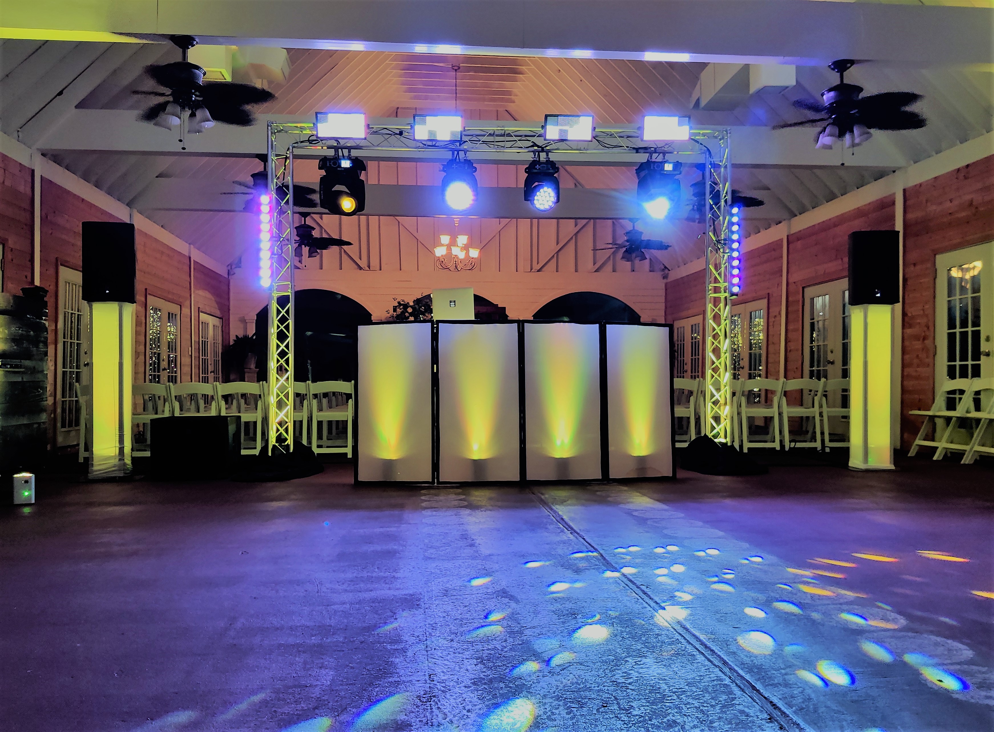 Deluxe DJ package with full truss arch and moving head lighting at a barn wedding venue