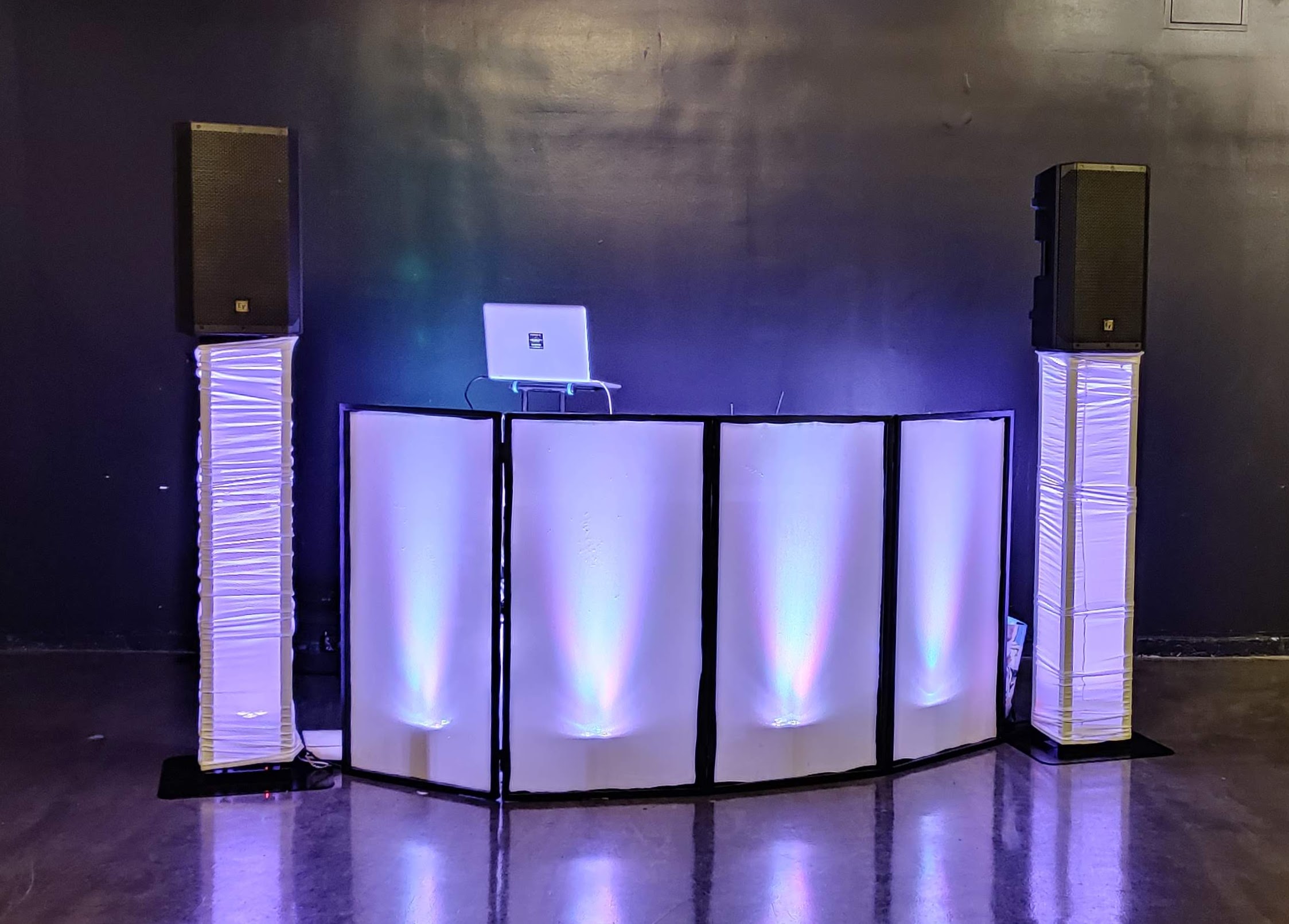 Party Starter DJ setup with uplit facade and column speakers